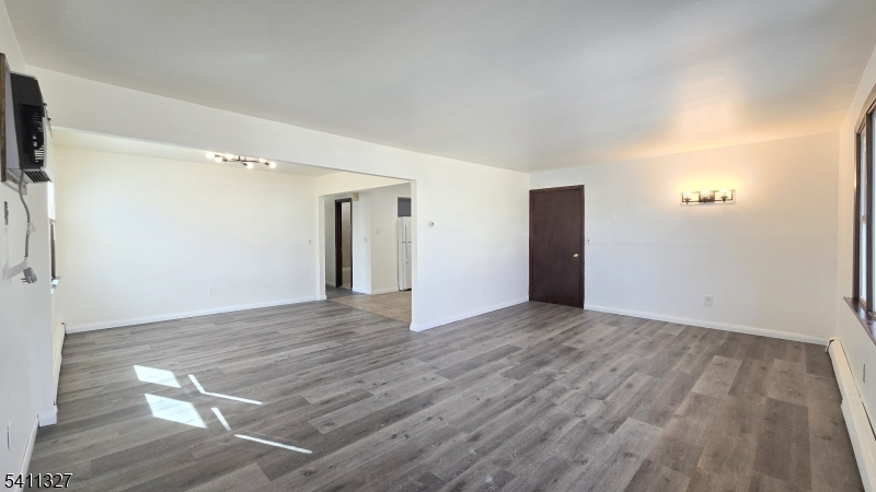 388 Garibaldi Avenue Lodi, NJ 07644 - Photo 2 of 20 a view of an empty room with wooden floor