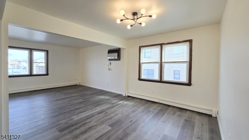 388 Garibaldi Avenue Lodi, NJ 07644 - Photo 4 of 20 wooden floor in an empty room with a window