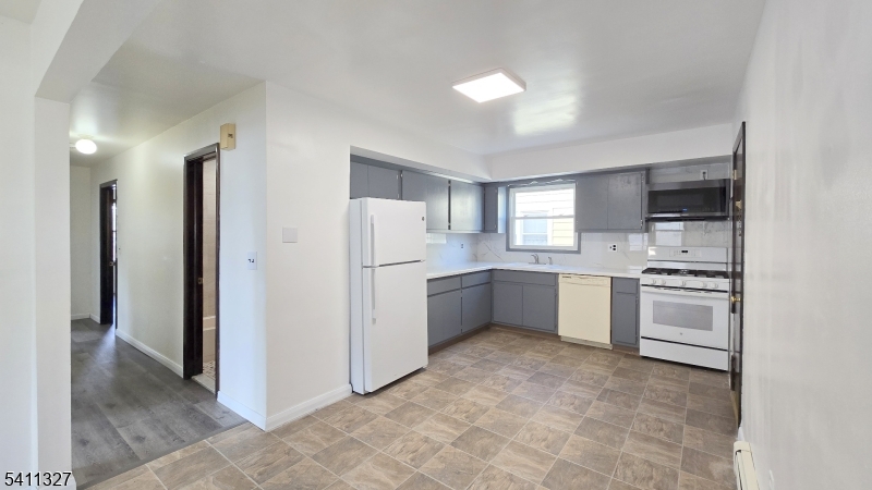 388 Garibaldi Avenue Lodi, NJ 07644 - Photo 5 of 20 a kitchen with a refrigerator and a sink