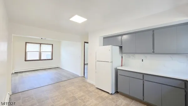 a view of kitchen with a refrigerator cabinets and a dishwasher