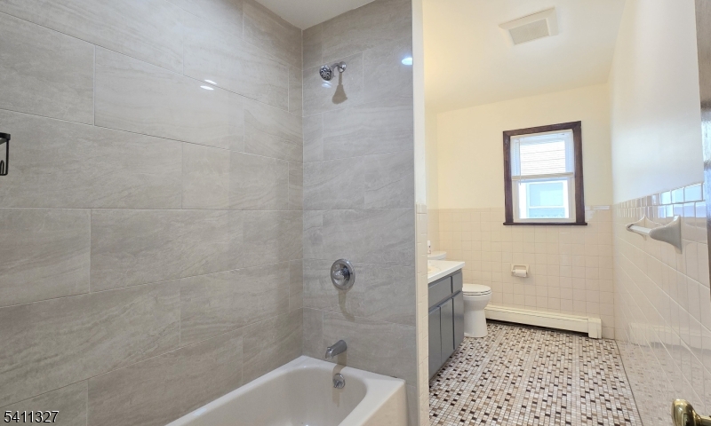 388 Garibaldi Avenue Lodi, NJ 07644 - Photo 9 of 20 a bathroom with a sink a toilet and shower