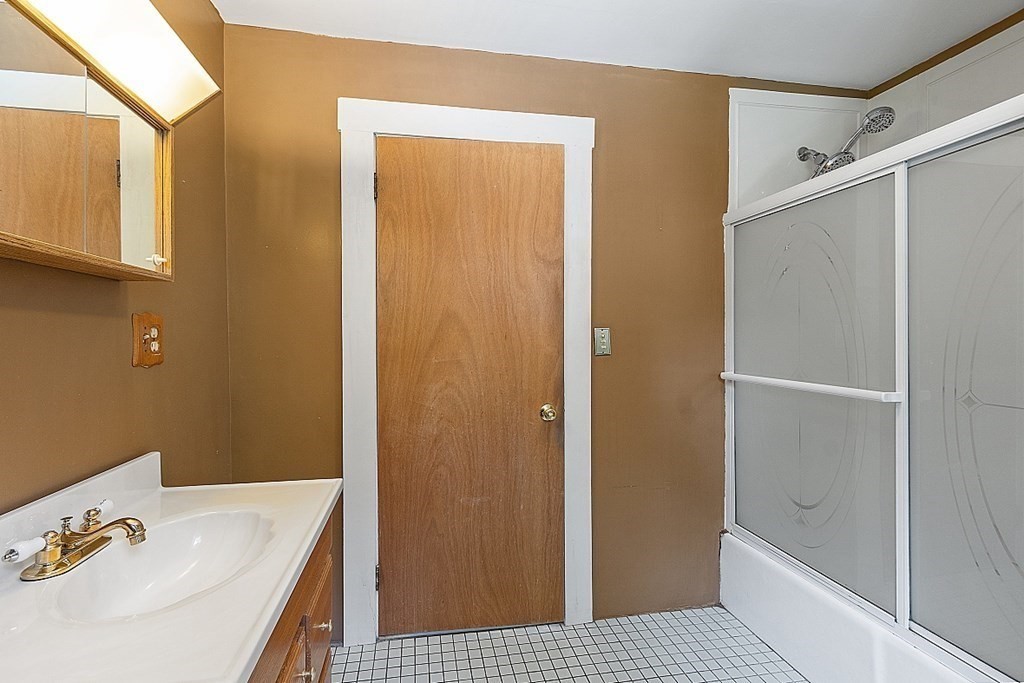 202 Beaconsfield Road Worcester, MA 01602 - Photo 17 of 38 a bathroom with a sink a mirror and a shower