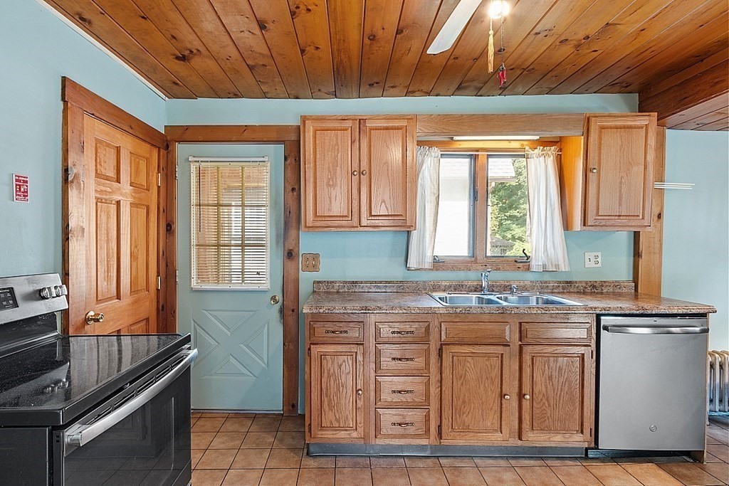 202 Beaconsfield Road Worcester, MA 01602 - Photo 25 of 38 a kitchen with stainless steel appliances granite countertop a stove a sink and a microwave