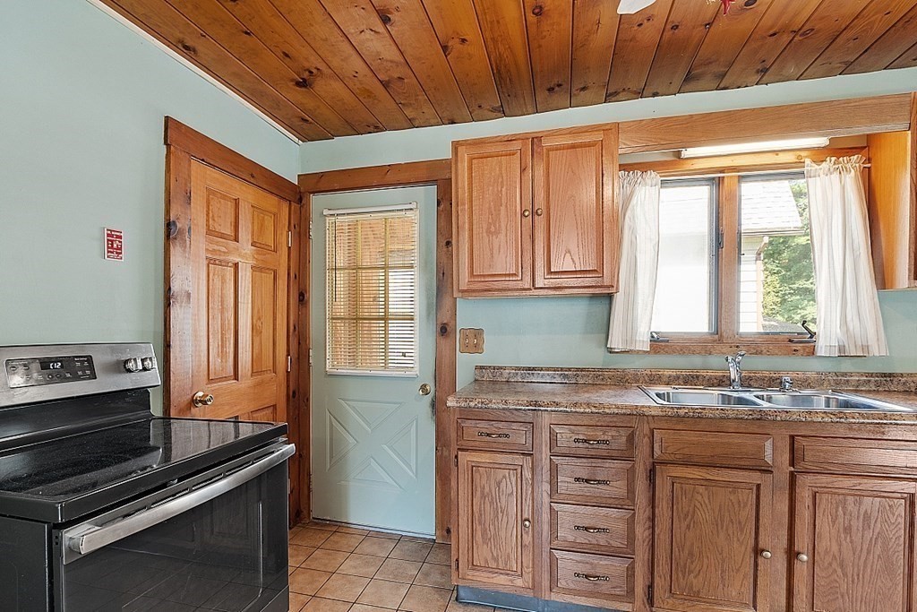 202 Beaconsfield Road Worcester, MA 01602 - Photo 26 of 38 a kitchen with granite countertop a sink cabinets stainless steel appliances and a window