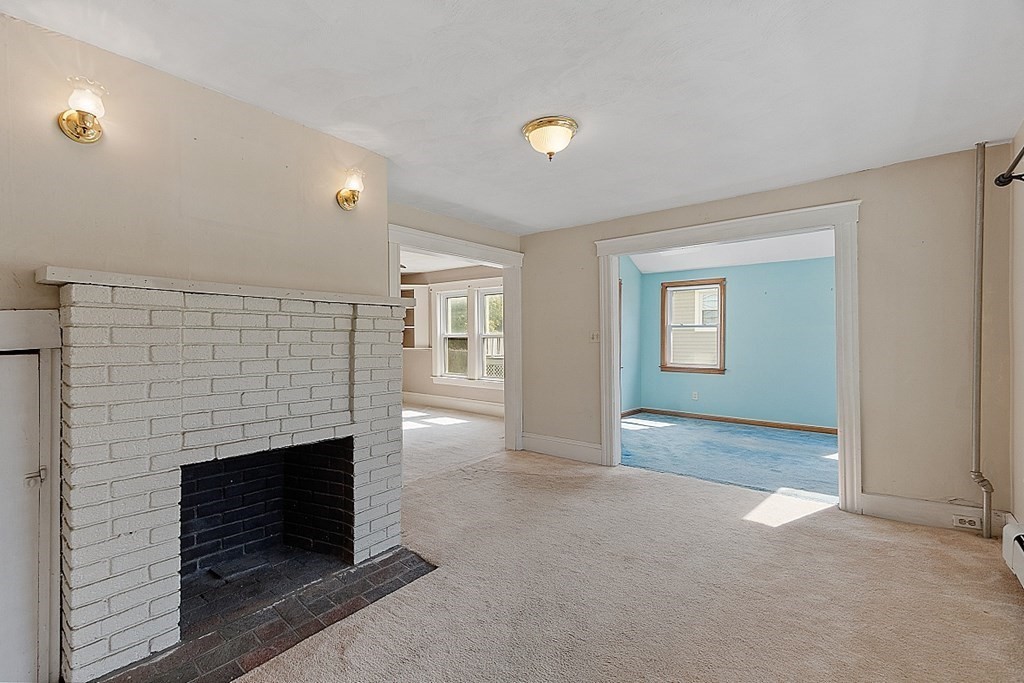 202 Beaconsfield Road Worcester, MA 01602 - Photo 8 of 38 an empty room with windows and fireplace