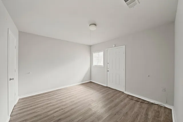a view of an empty room and wooden floor