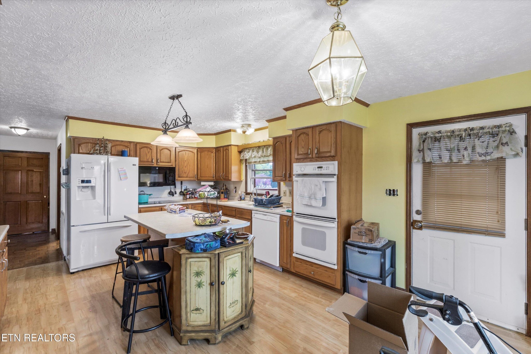 226 Thacker Drive La Follette, TN 37766 - Photo 11 of 51 a kitchen with stainless steel appliances kitchen island granite countertop a table chairs and a refrigerator