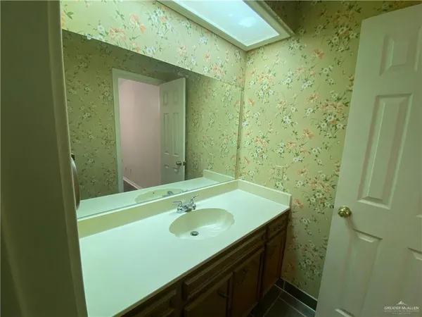 a kitchen with a refrigerator sink and cabinets