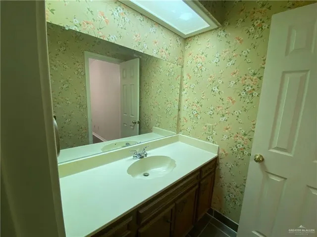 a kitchen with a refrigerator sink and cabinets