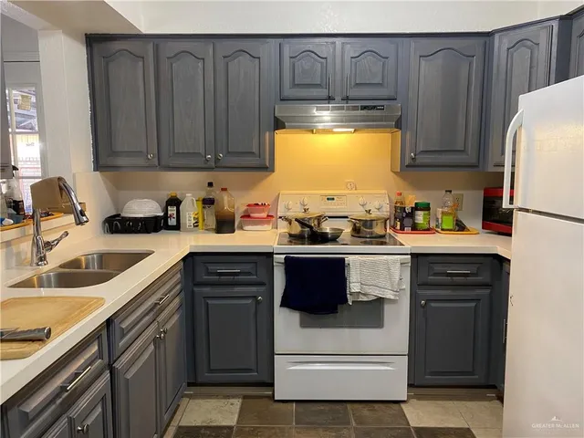 a view of a house with a yard and tree