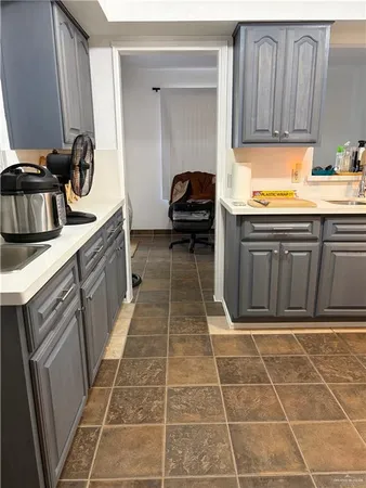 a view of a backyard with large tree and wooden fence