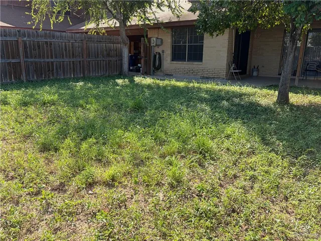 a patio with a table and chairs under an umbrella