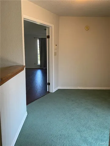 an empty room with closet and mirror