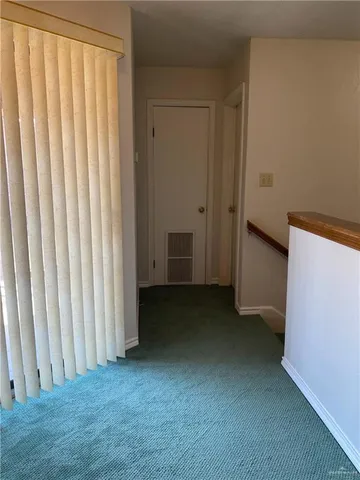 a view of a closet area with hardwood floor