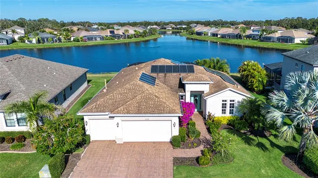 an aerial view of a house with a ocean view