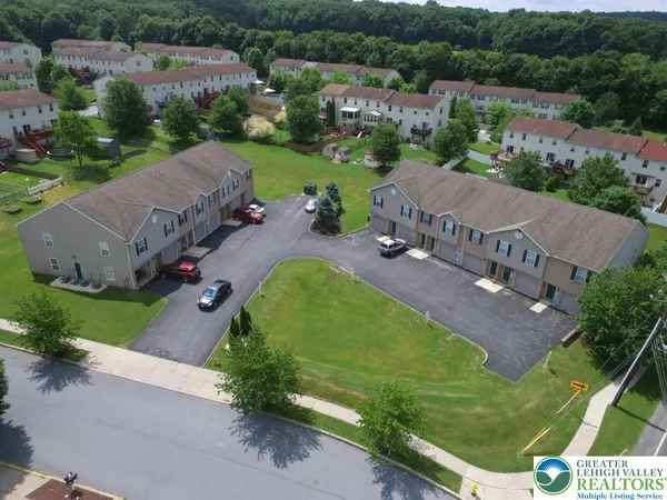an aerial view of a house with a garden and trees
