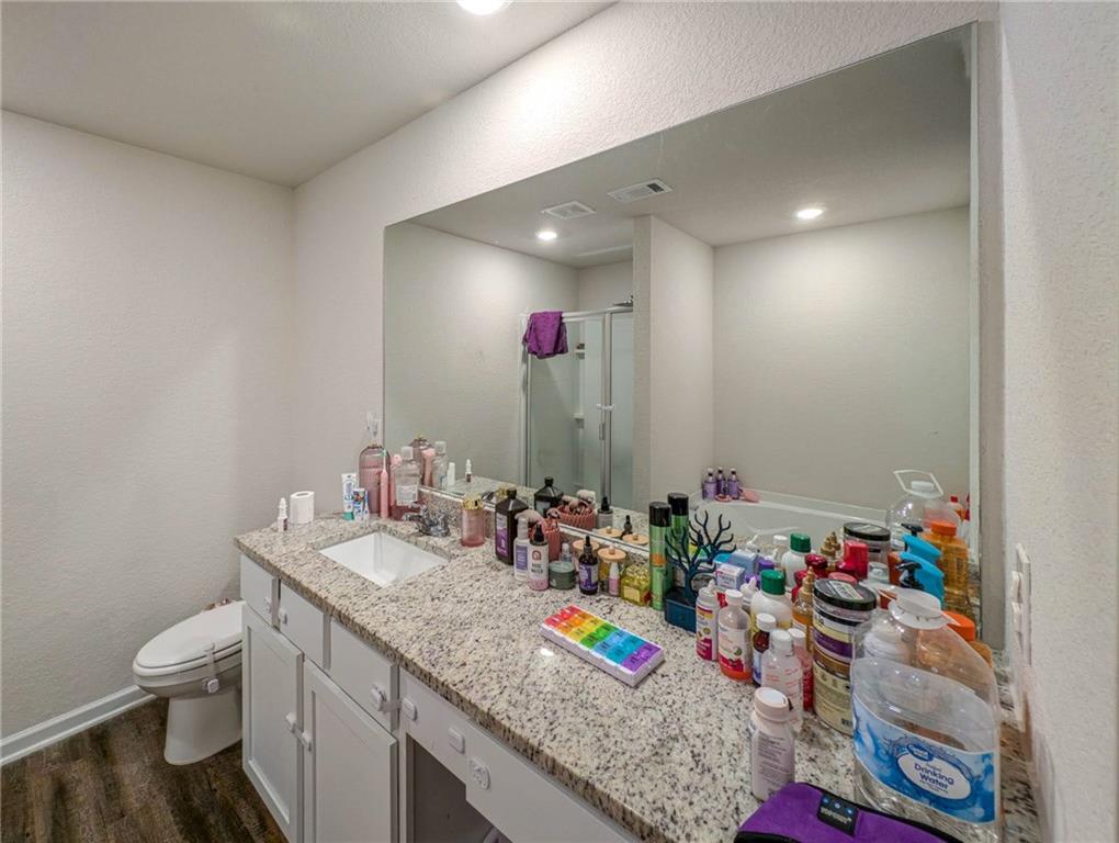 635 Meadows Farm Way Monroe, GA 30655 - Photo 23 of 36 a bathroom with a granite countertop sink a large mirror and shower