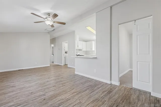 a view of an empty room with wooden floor