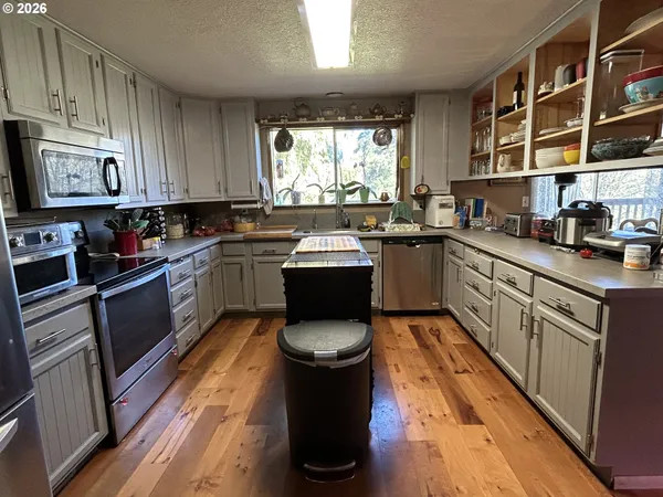 a kitchen with a sink stove and cabinets