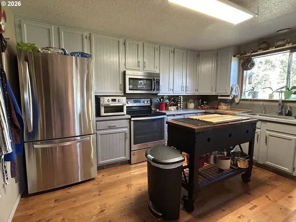 a kitchen with a sink appliances and cabinets