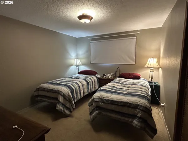 a bedroom with two beds and a night stand