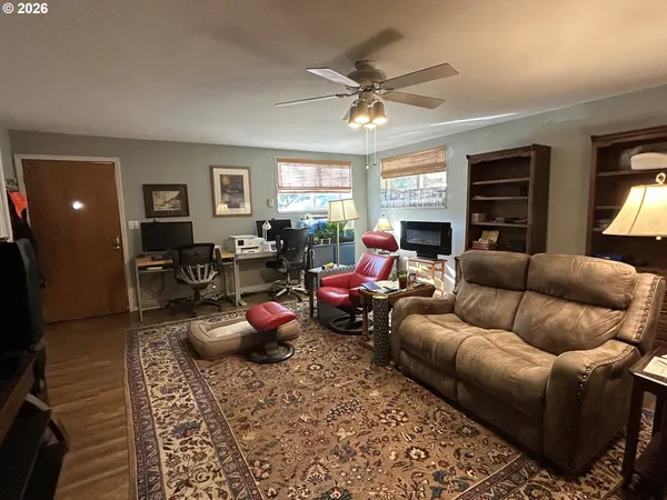 a living room with furniture a window and a flat screen tv