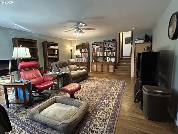 a living room with furniture a rug and a flat screen tv