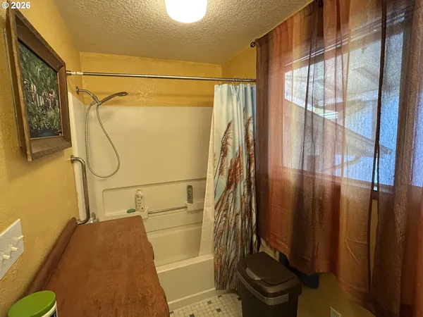 a bathroom with a shower and a toilet