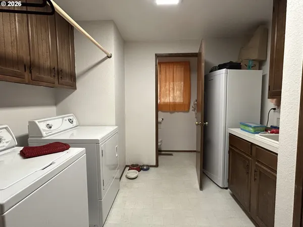 a view of storage and utility room with washer and dryer