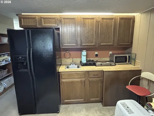 a kitchen with a refrigerator and sink