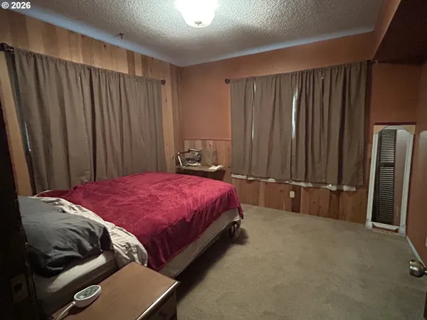 a bedroom with a bed and a mirror