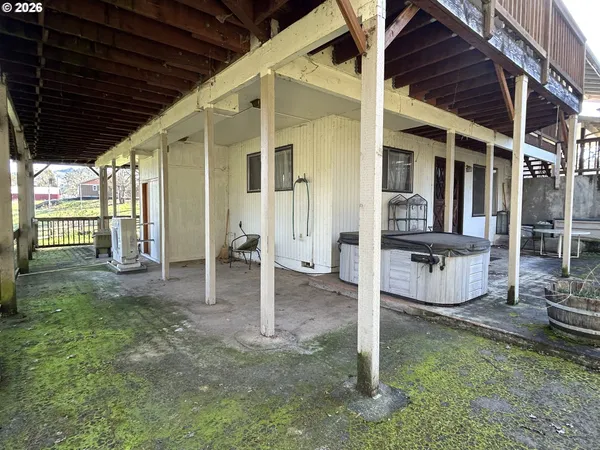 a view of an house with backyard space and balcony