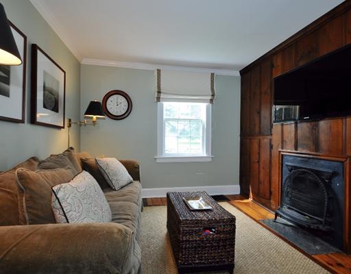 334 Hollow Tree Ridge Road Darien, CT 06820 - Photo 11 of 20 a living room with furniture a fireplace and a window