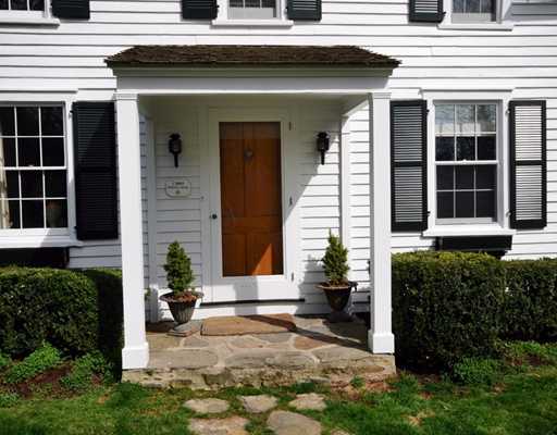 334 Hollow Tree Ridge Road Darien, CT 06820 - Photo 2 of 20 a view of a house with potted plants and a table and chairs