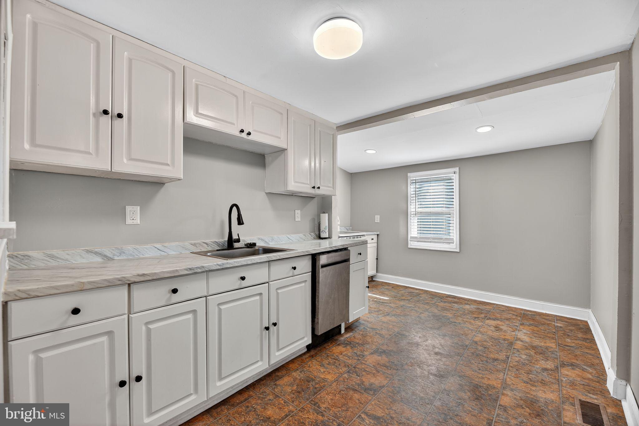 1138 Fourth Avenue Croydon, PA 19021 - Photo 5 of 15 a kitchen with white cabinets and sink