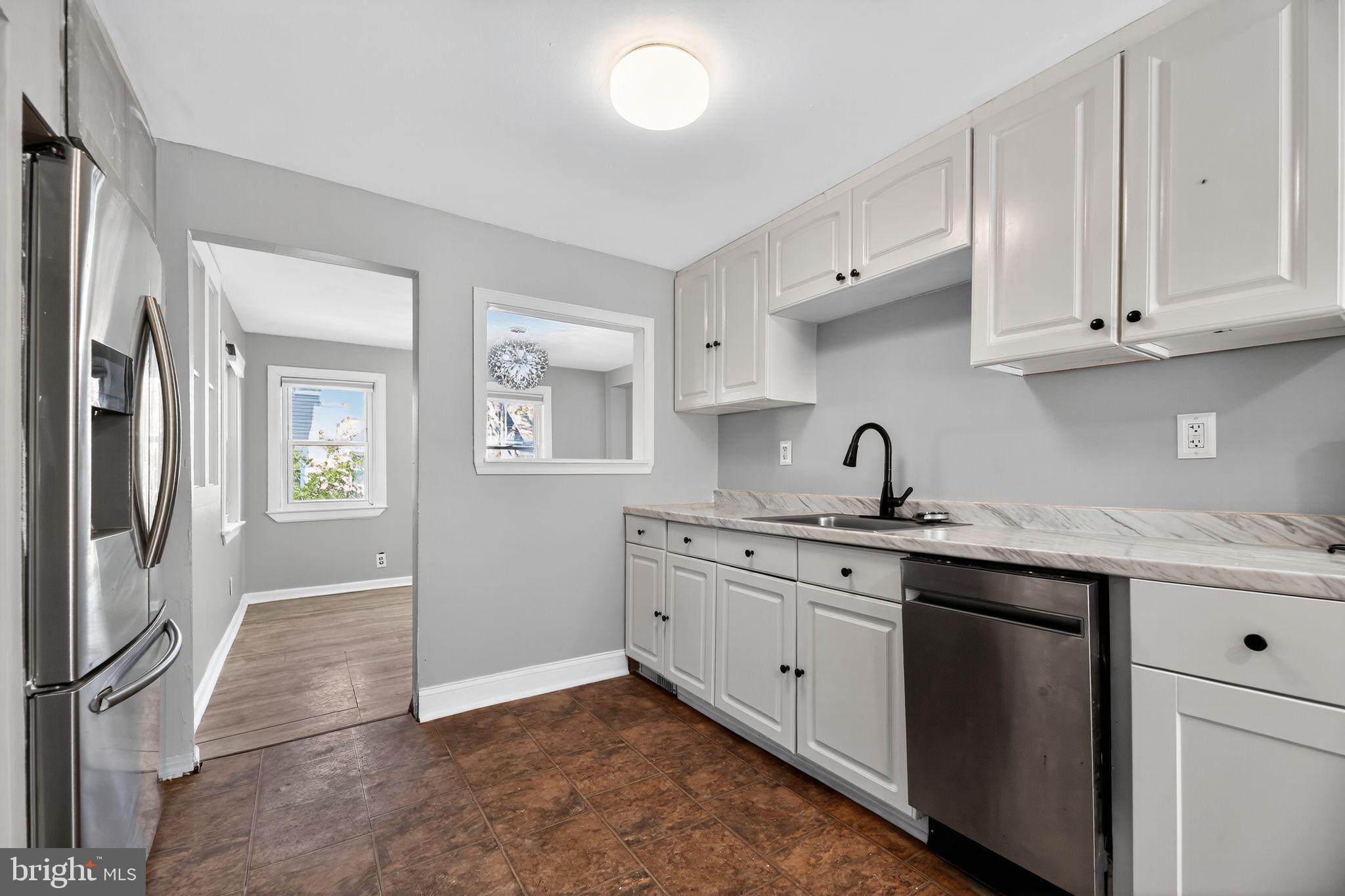1138 Fourth Avenue Croydon, PA 19021 - Photo 6 of 15 a kitchen with a sink stove and cabinets