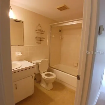 a bathroom with a toilet a sink and shower