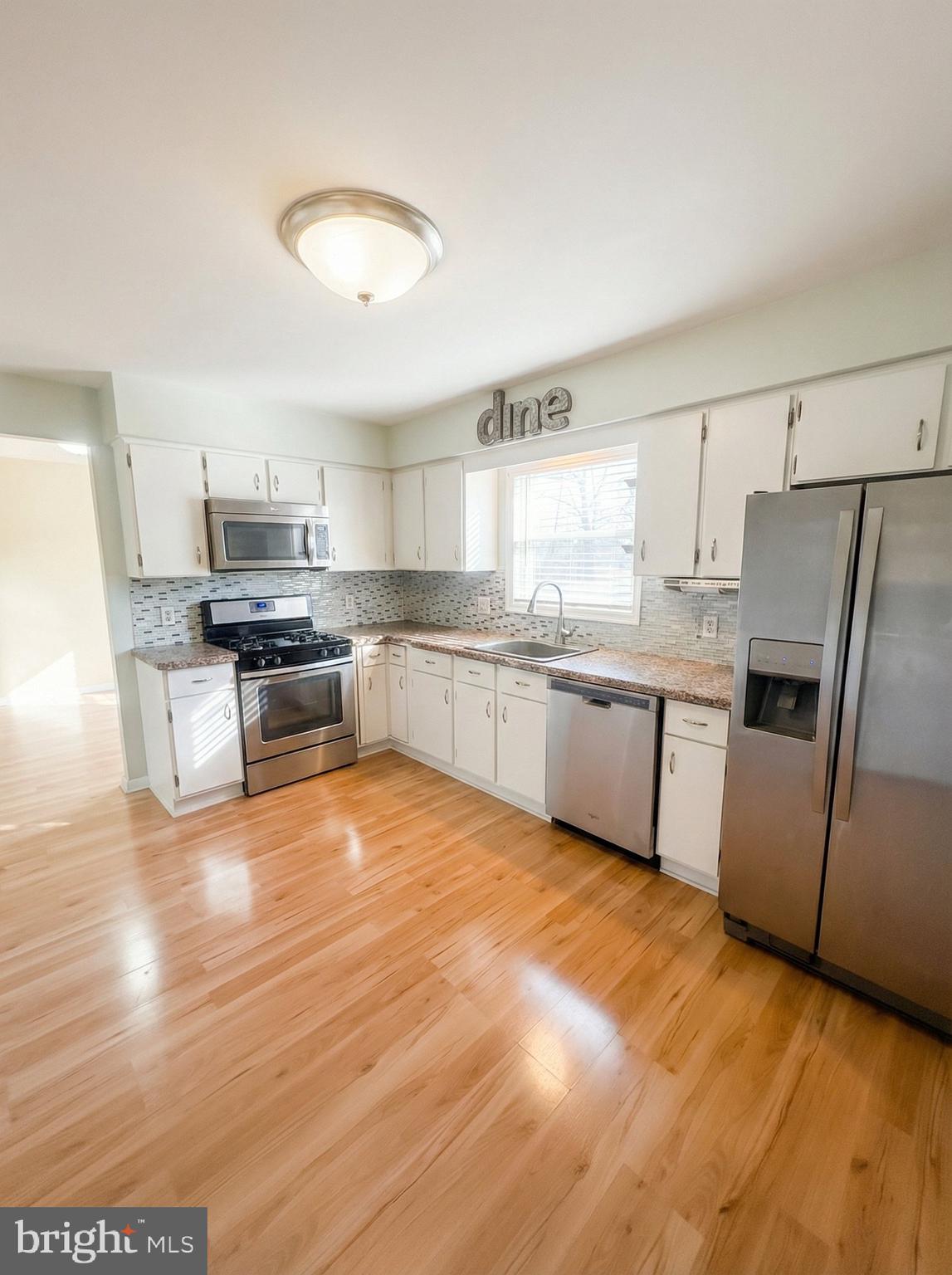970 Haines Road York, PA 17402 - Photo 8 of 20 a kitchen with stainless steel appliances granite countertop a stove a sink dishwasher and a refrigerator