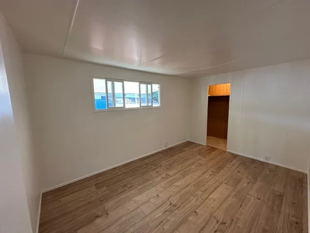 an empty room with windows and entrance
