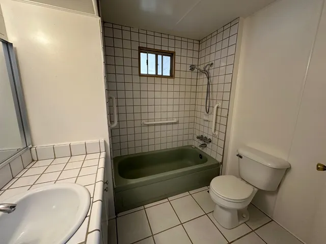 a bathroom with a sink a toilet and bathtub