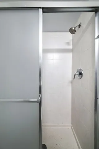 a bathroom with a glass shower door