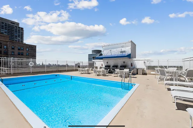 a view of a swimming pool and chairs