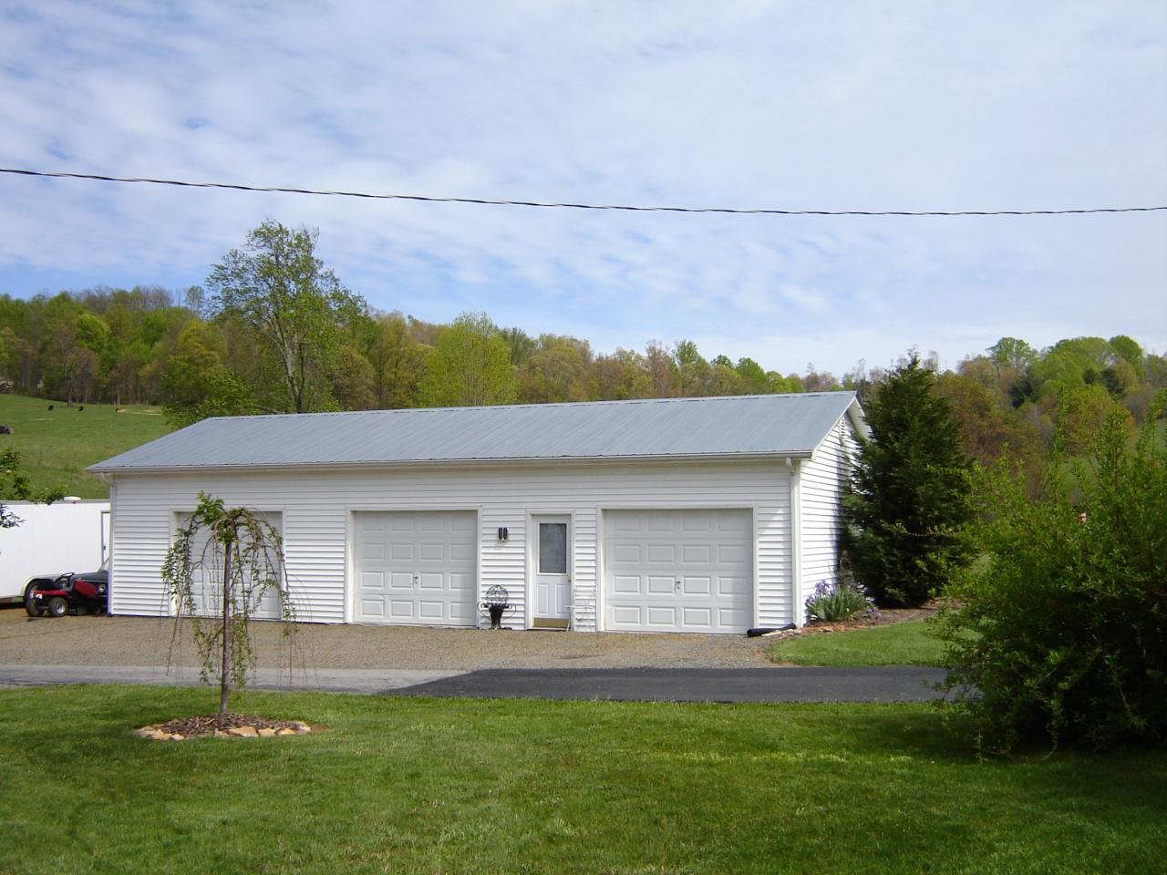 367 Conner Grove Road Southwest Willis, VA 24380 - Photo 4 of 22 a front view of a house with a garden and yard