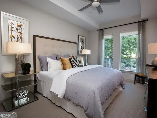 a spacious bedroom with a bed and a chandelier
