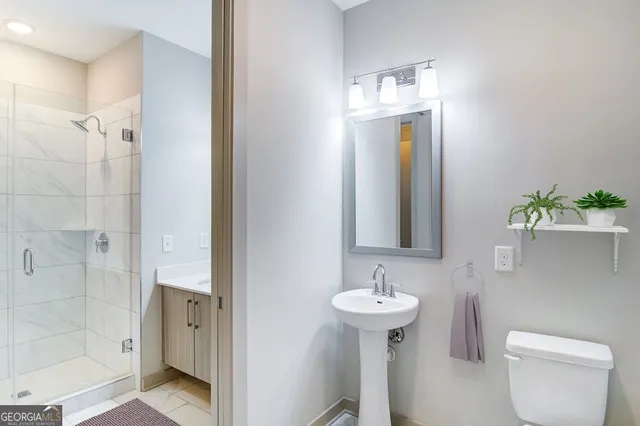 a bathroom with a shower and mirror
