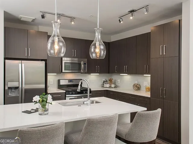 a living room with furniture and kitchen view