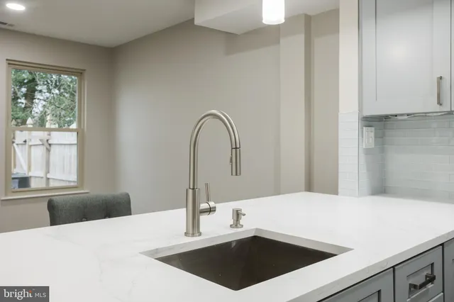 a close view of a sink a faucet and a window