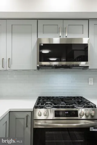 a stove top oven sitting inside of a kitchen