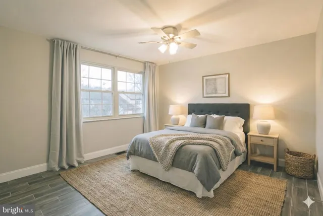 a spacious bedroom with a bed and a chandelier
