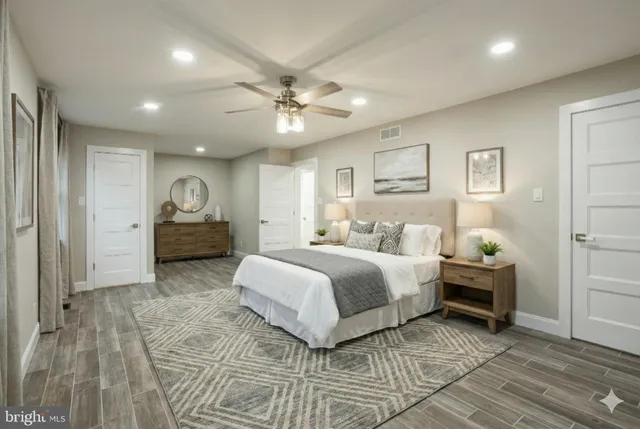 a spacious bedroom with a bed and a chandelier
